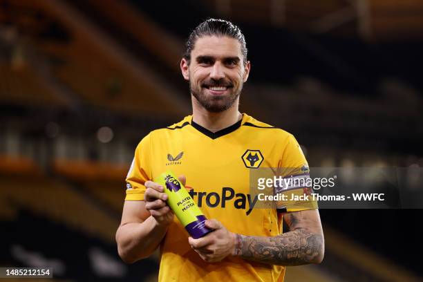 Ruben Neves of Wolverhampton Wanderers poses for a photo with the Premier League Player of the Match award after the team's victory in the Premier...