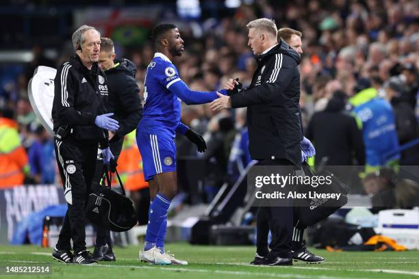 Kelechi Iheanacho of Leicester City shakes hands with Dean Smith, Manager of Leicester City after being substituted off after receiving medical...