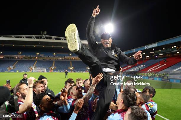 Vincent Kompany, Manager of Burnley, is lifted up by his players after winning the Sky Bet Championship following victory in the Blackburn Rovers and...