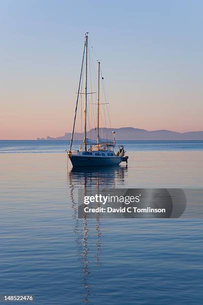 yacht anchored in bay off presqu'ile de giens with island of porquerolles in background. - hyeres bildbanksfoton och bilder