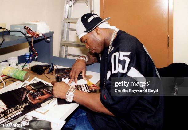 Rapper 50 Cent signs autographs during a visit to 106 Jamz radio in Lansing, Illinois in January 2003.