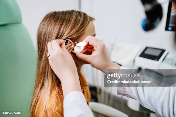 medical hearing examination - ear exam stock pictures, royalty-free photos & images