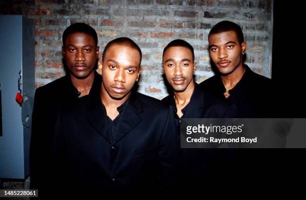 Singers Quinnes 'Q' Parker, Michael 'Mike' Keith, Marvin 'Slim' Scandrick and Daron Jones of 112 poses for photos in between takes of filming the...