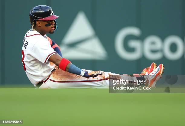 Ronald Acuna Jr. #13 of the Atlanta Braves reacts after hitting a double to lead off the first inning against the Miami Marlins at Truist Park on...
