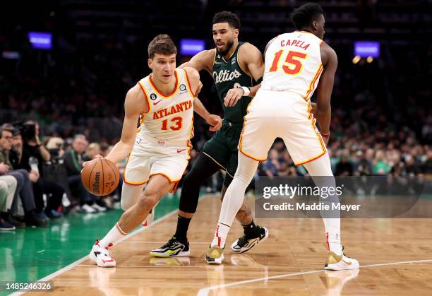 Bogdan Bogdanovic of the Atlanta Hawks drives to the basket against Jayson Tatum of the Boston Celtics during the first quarter in game five of the...