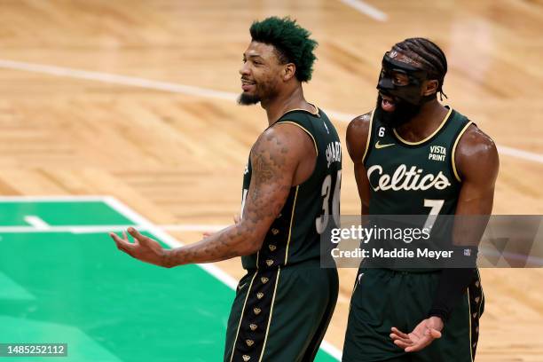 Marcus Smart and Jaylen Brown of the Boston Celtics react against the Atlanta Hawks during the second quarter in game five of the Eastern Conference...