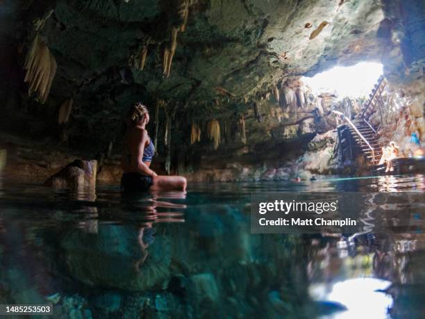 woman sitting in  cenote in yucatan in mexico - campeche stock pictures, royalty-free photos & images