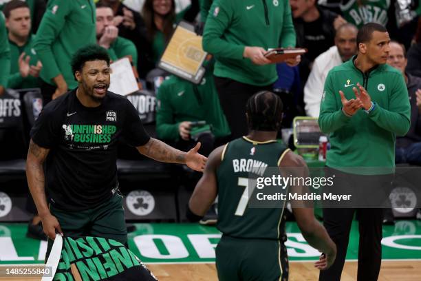 Marcus Smart of the Boston Celtics celebrates a basket with Jaylen Brown against the Atlanta Hawks during the second quarter in game five of the...