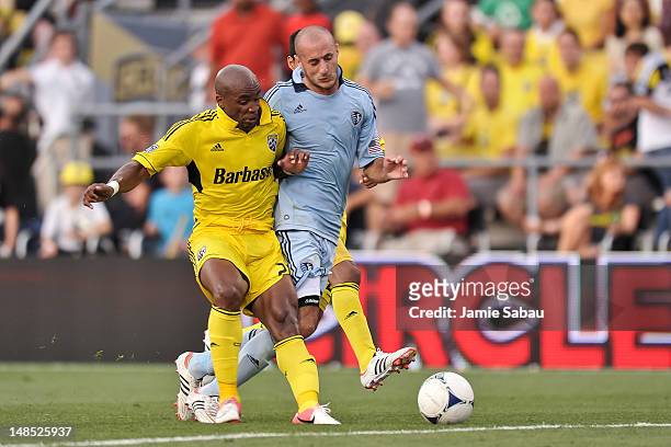 Emilio Renteria of the Columbus Crew and Aurelien Collin of Sporting Kansas City battle for control of a loose ball on July 14, 2012 at Crew Stadium...