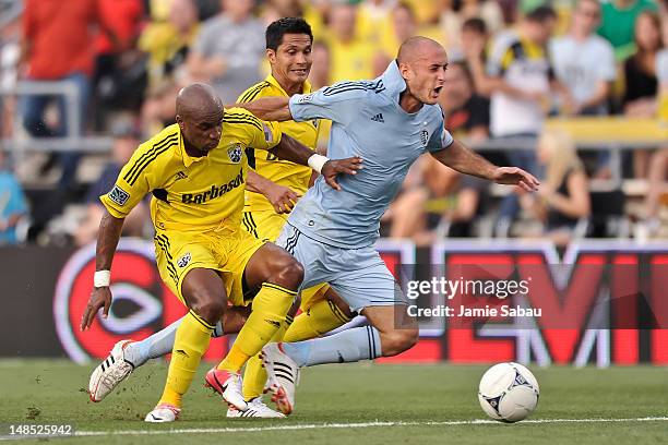 Emilio Renteria of the Columbus Crew and Aurelien Collin of Sporting Kansas City battle for control of a loose ball on July 14, 2012 at Crew Stadium...