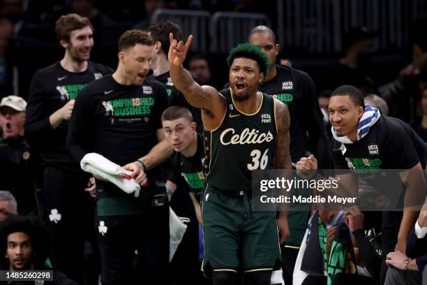 Marcus Smart of the Boston Celtics celebrates from the bench against the Atlanta Hawks during the third quarter in game five of the Eastern...