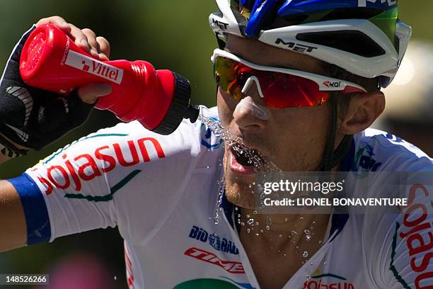 One of the two leading men, France's Romain Feuillu drinks as he rides in a breakaway in the 197 km and sixteenth stage of the 2012 Tour de France...