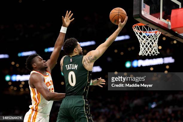 Jayson Tatum of the Boston Celtics shoots the ball against Clint Capela of the Atlanta Hawks during the third quarter in game five of the Eastern...