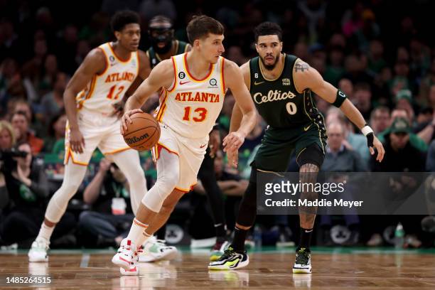 Bogdan Bogdanovic of the Atlanta Hawks dribbles against Jayson Tatum of the Boston Celtics during the third quarter in game five of the Eastern...