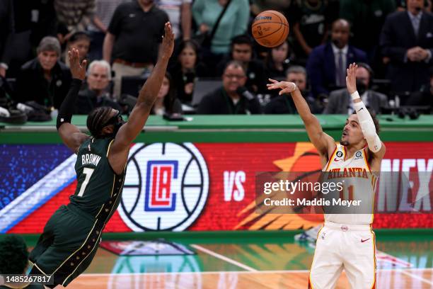 Trae Young of the Atlanta Hawks shoots the game winning 29-foot three point basket against Jaylen Brown of the Boston Celtics during the fourth...