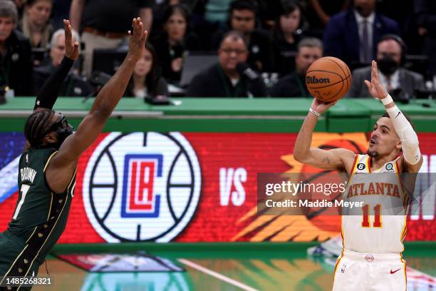 Trae Young of the Atlanta Hawks shoots the game winning 29-foot three point basket against Jaylen Brown of the Boston Celtics during the fourth...