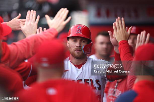 Brandon Drury of the Los Angeles Angels celebrates with teammates after scoring against the Oakland Athletics during the first inning at Angel...