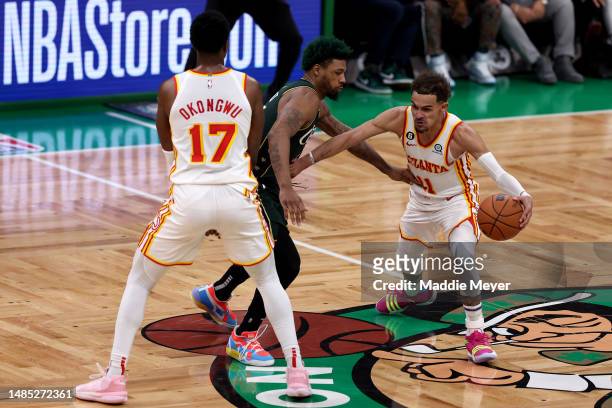 Trae Young of the Atlanta Hawks dribbles against Marcus Smart of the Boston Celtics during the fourth quarter in game five of the Eastern Conference...