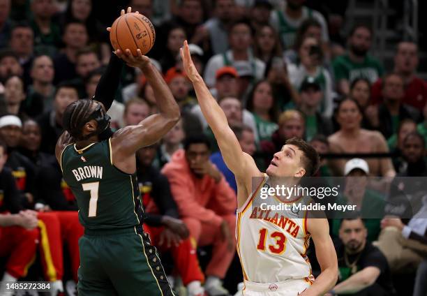 Jaylen Brown of the Boston Celtics shoots the ball against Bogdan Bogdanovic of the Atlanta Hawks during the fourth quarter in game five of the...