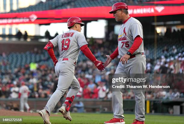 Tommy Edman of the St. Louis Cardinals celebrates his solo home run in the third inning with third base coach Ron "Pop" Warner against the San...