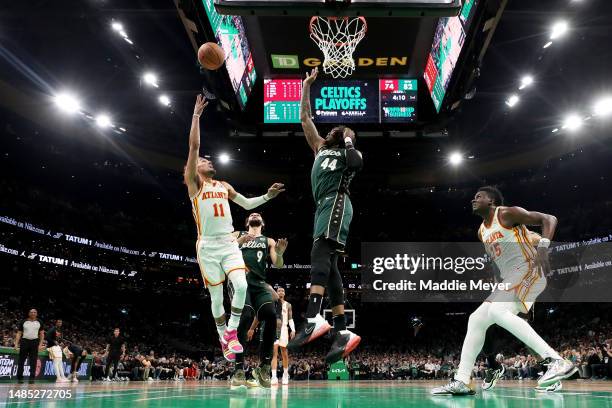 Trae Young of the Atlanta Hawks shoots the ball against Robert Williams III of the Boston Celtics during the third quarter in game five of the...