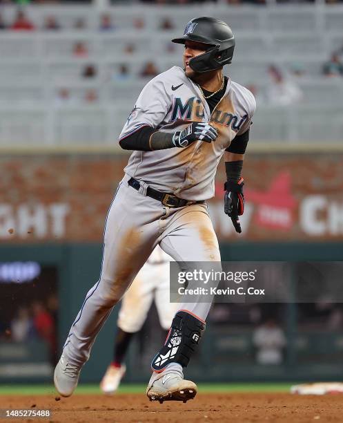 Yuli Gurriel of the Miami Marlins rounds third base as he hits an in-the-park home run against the Atlanta Braves at Truist Park on April 25, 2023 in...