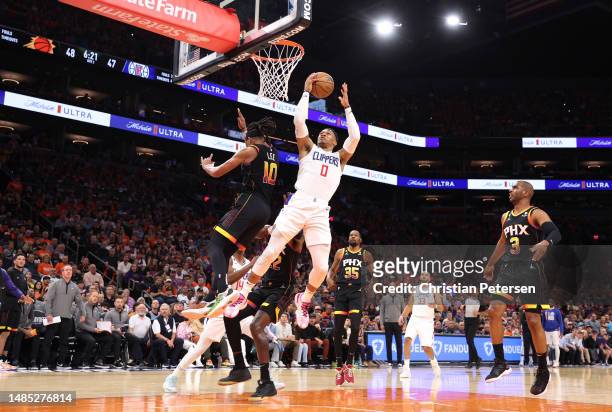 Russell Westbrook of the LA Clippers drives to the basket against Damion Lee of the Phoenix Suns during the second quarter in game five of the...