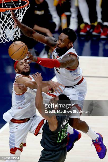 Bruce Brown and Jeff Green of the Denver Nuggets block Mike Conley of the Minnesota Timberwolves in the fourth quarter during Round 1 Game 5 of the...