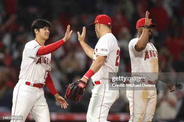 Shohei Ohtani of the Los Angeles Angels celebrates with his teammate Mike Trout after defeating the Oakland Athletics, 5-3, during the ninth inning...