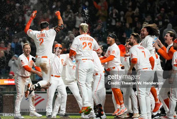 Blake Sabol of the San Francisco Giants celebrates his walk-off, two-run home run with teammates in the bottom of the ninth inning to defeat the St....