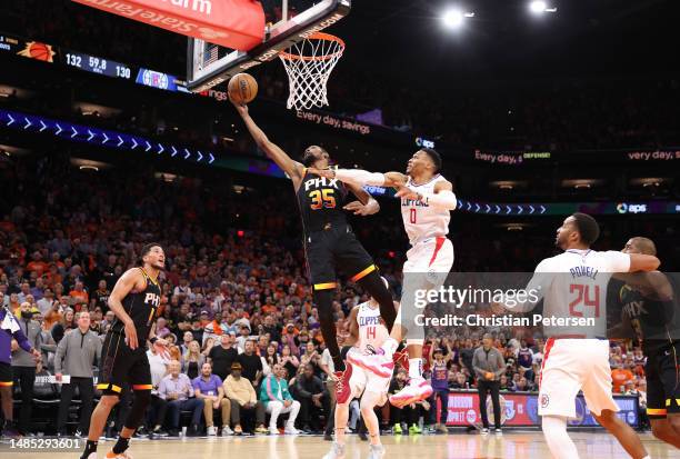 Kevin Durant of the Phoenix Suns shoots the ball against Russell Westbrook of the LA Clippers during the fourth quarter in game five of the Western...