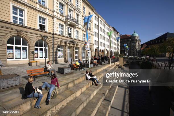 people relaxing in street in city centre. - bayreuth stock pictures, royalty-free photos & images