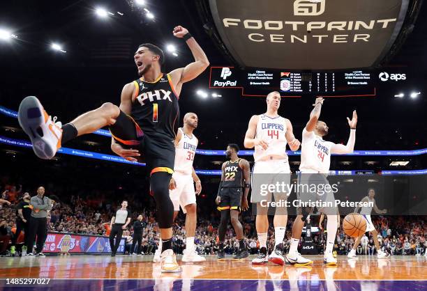 Devin Booker of the Phoenix Suns reacts after dunking the ball during the third quarter against the LA Clippers in game five of the Western...