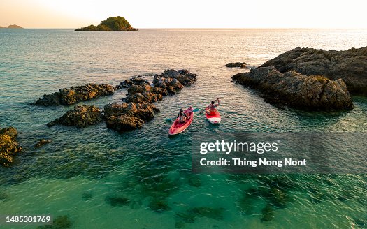 Aerial view - Two women enjoy the water aqua sport on the seaside. Aerial view - Two women enjoy the water aqua sport on the seaside.