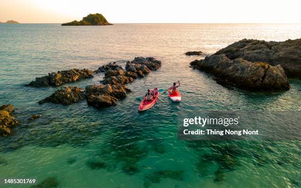 aerial view - two women enjoy the water aqua sport on the seaside. - imbarcazione per passeggeri foto e immagini stock