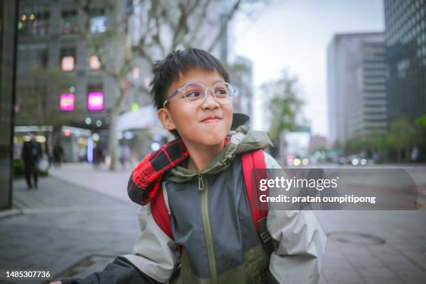 happy boy in big city - happy asian boy stock pictures, royalty-free photos & images