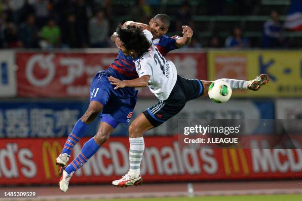 Patric of Ventforet Kofu and Yuji Nakazawa of Yokohama F.Marinos compete for the ball during the J.League J1 match between Ventforet Kofu and...