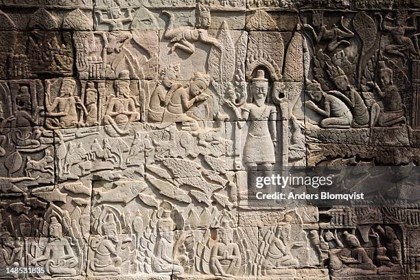 detail of bas relief depcting worship of king on the bayon , angkor thom. - king of cambodia stock pictures, royalty-free photos & images