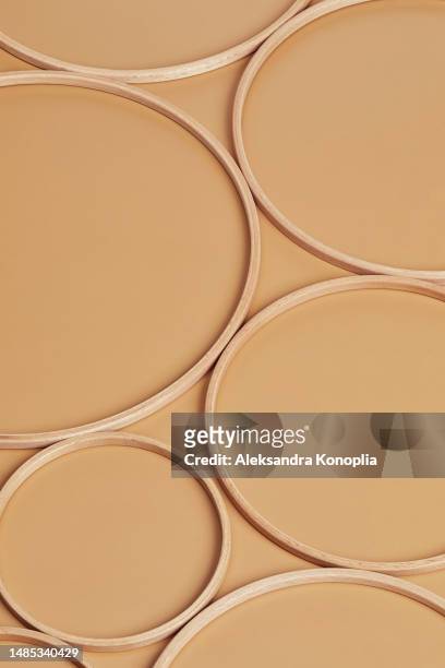 abstract minimal scene with geometric composition of natural wooden circles on soft beige background, isometric view - together abstract stock pictures, royalty-free photos & images
