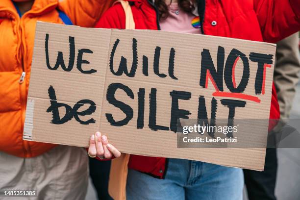 people holding a cardboard message - protest banner stock pictures, royalty-free photos & images