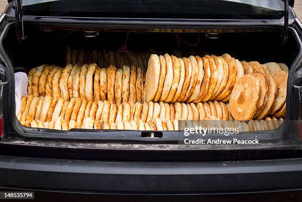 car trunk full of freshly made bread for delivery to stores in town. - full car trunk stock pictures, royalty-free photos & images