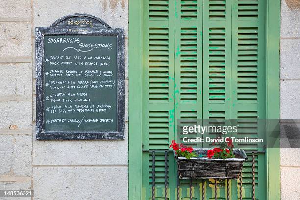 menu board and green shutters of the so caprichos restaurant. - chalkboard menu stock pictures, royalty-free photos & images