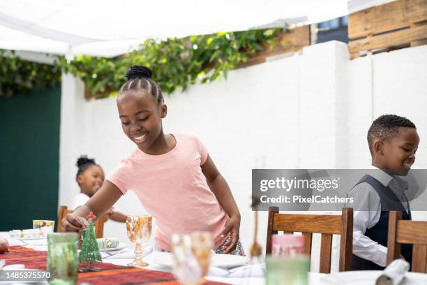 excited children around christmas dinner table - setting the table stock pictures, royalty-free photos & images