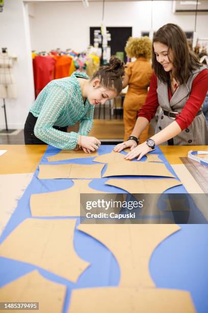 students tracing out clothing patterns on fabric - träslag bildbanksfoton och bilder