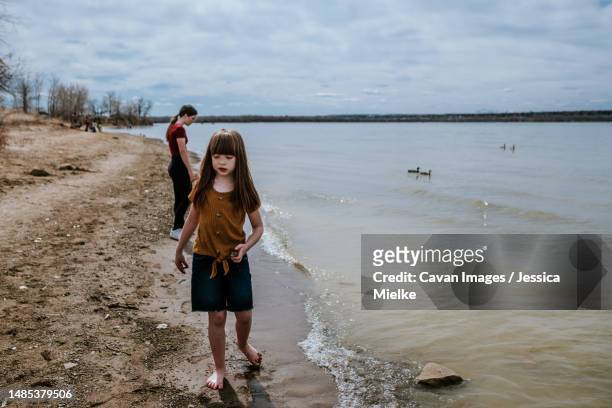 siblings standing next to lake on sunny day - denver summer stock pictures, royalty-free photos & images