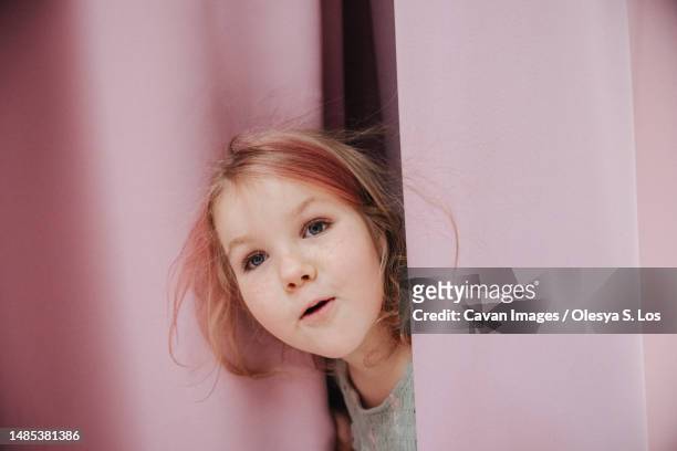 surprised girl on the background of pink curtains - six girl stock-fotos und bilder