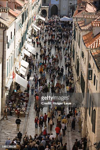 pedestrians on placa in old town, seen from city wall. - dubrovnik old town stock pictures, royalty-free photos & images