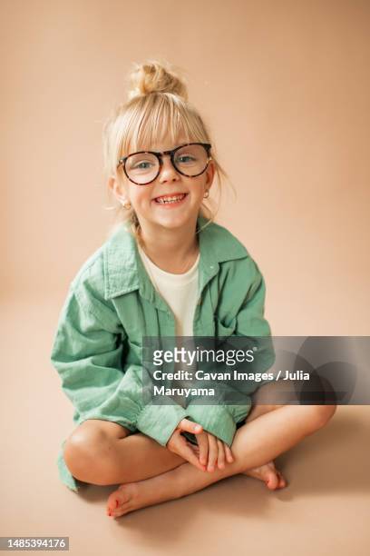 happy portrait of cute little toddler girl with glasses smiling - blonde glasses stock-fotos und bilder