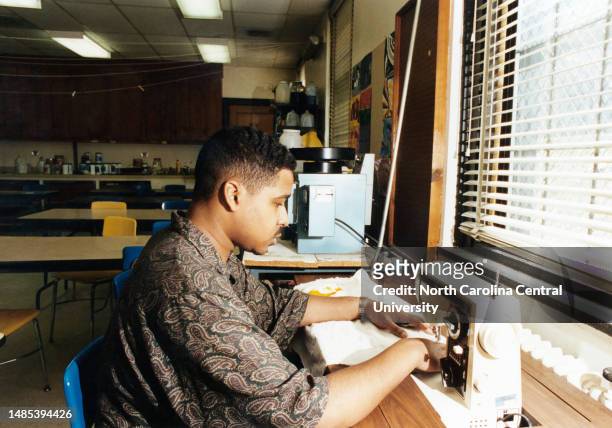 North Carolina Central University student using a sewing machine in the 1990s.