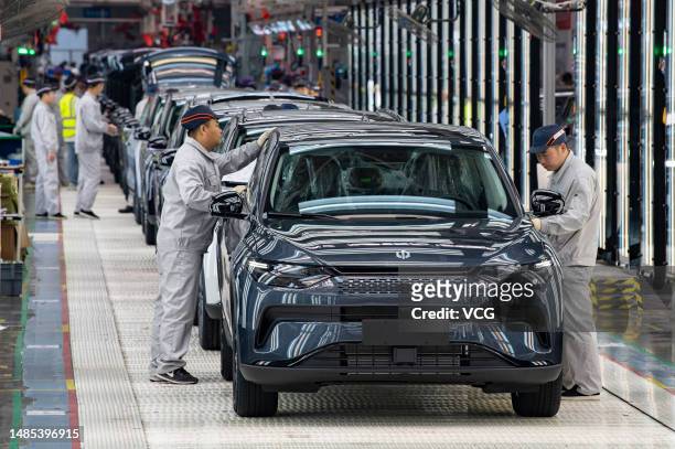 Employees work on the assembly line of C11 electric SUV at a factory of Chinese EV startup Leapmotor on April 26, 2023 in Jinhua, Zhejiang Province...